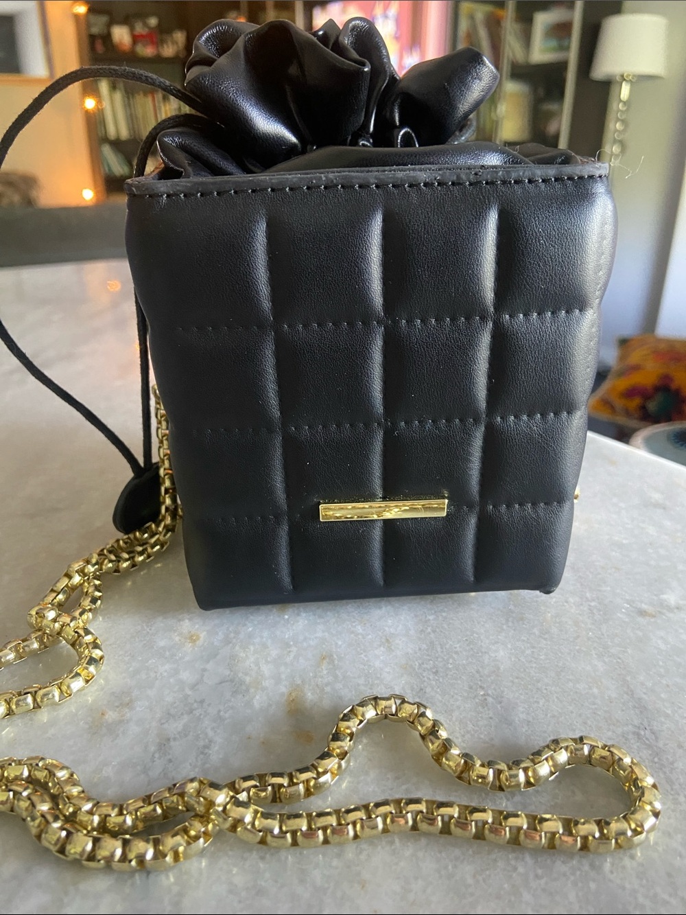 Black Quilted Drawstring Crossbody Bag with Gold Chain